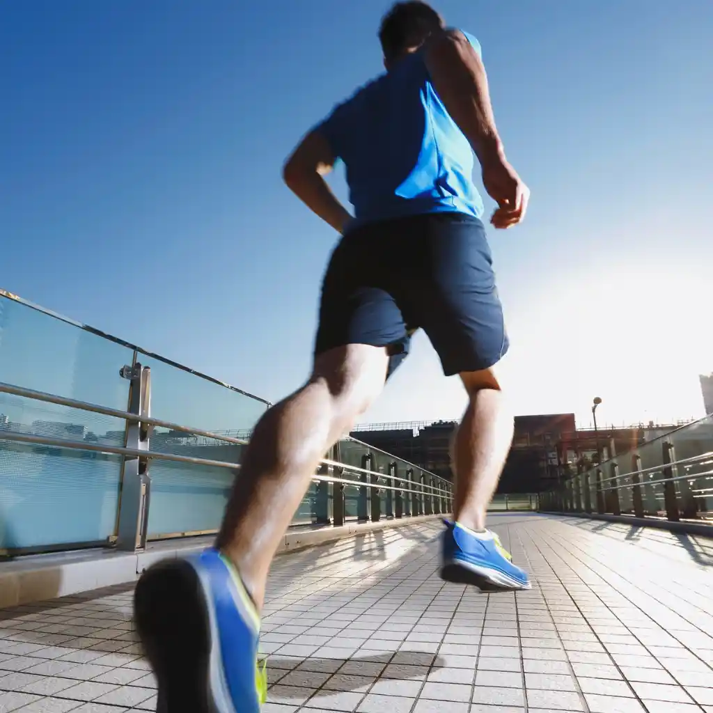 Runner demonstrating the active movement supported by treatment for chronic foot and ankle pain